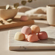 Maya CREATINE+ pink gummies close up on marble board